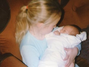 Caroline is allowed to hold Baby Tristan.