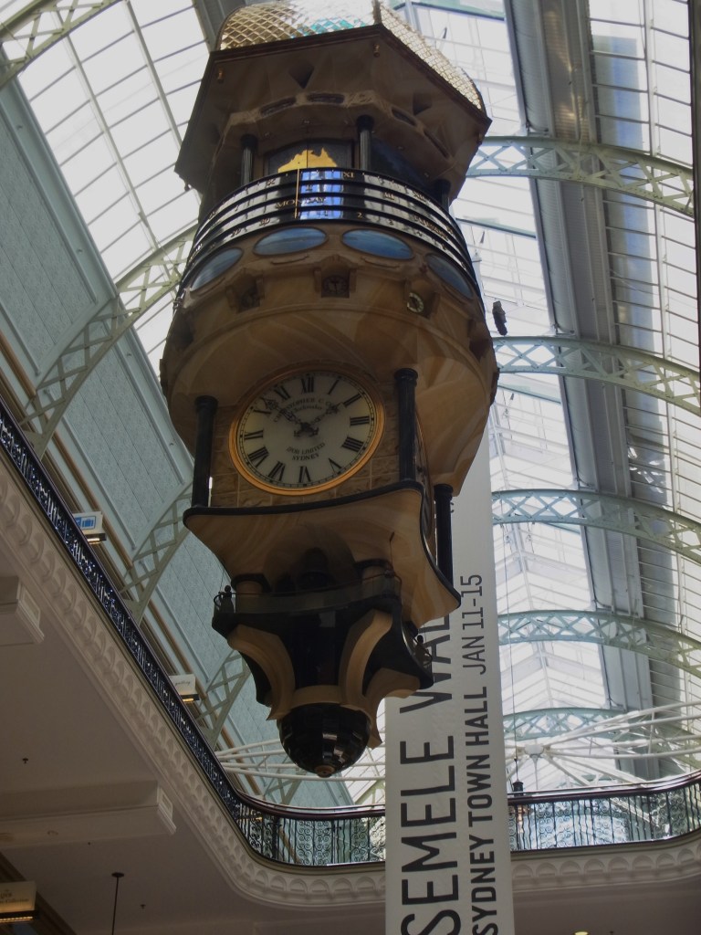 The huge clock inside of Queen Victoria Building.
