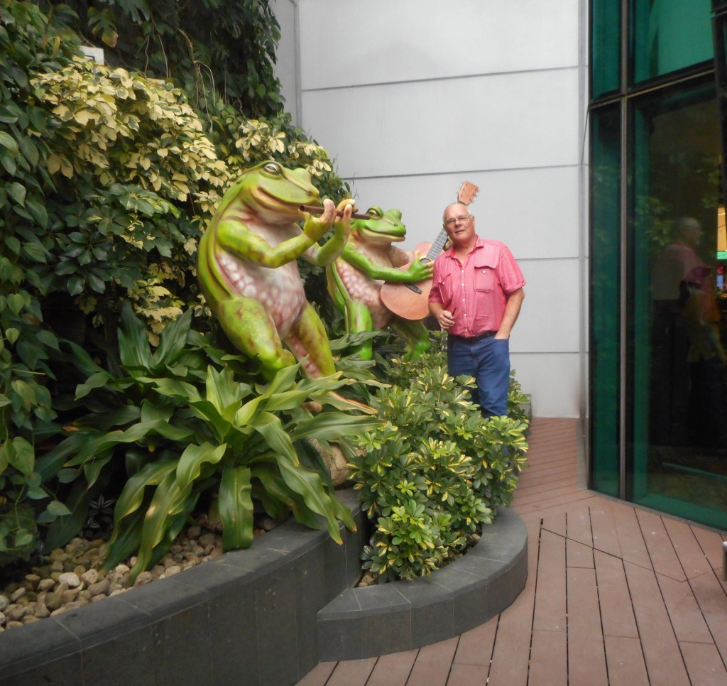 Martin posing for a photo in the outside garden area of Singapore Airport Evening of 1st of July 2016