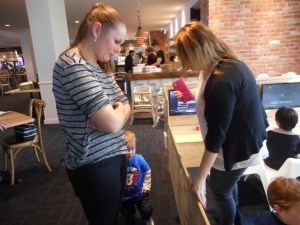 Ebony and Natasha are about to take the children back to the table for the cutting of the Birthday Cake!